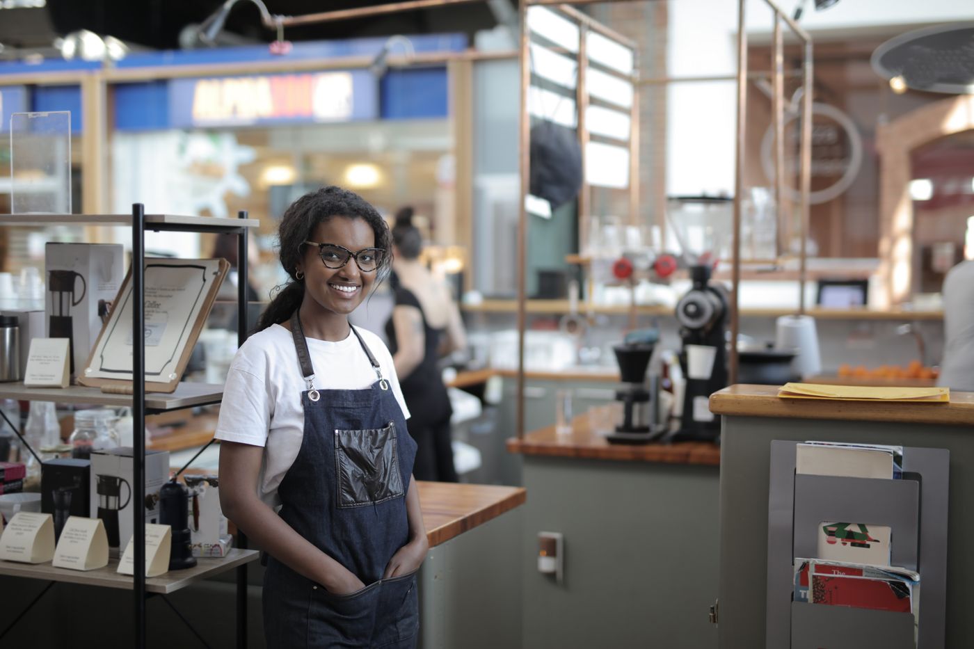 A small business owner standing in her café in Melbourne