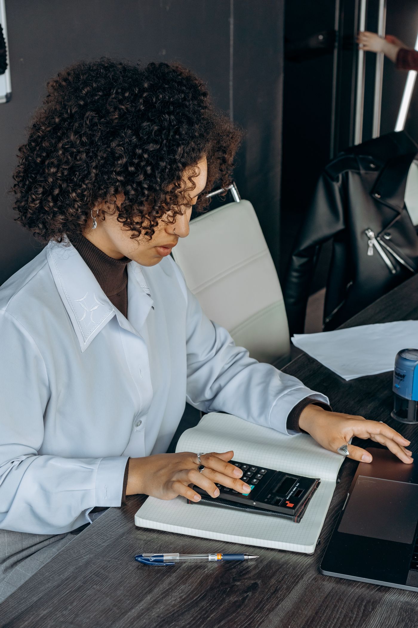 Nadia running figures at her desk